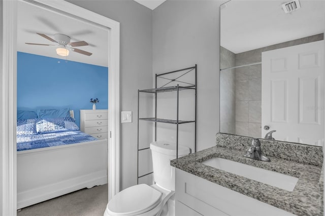 bathroom with vanity, toilet, and ceiling fan