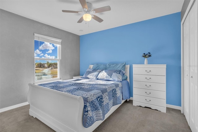 carpeted bedroom featuring a closet and ceiling fan