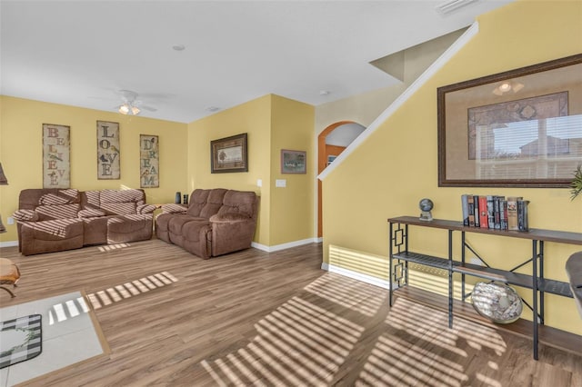 living room featuring ceiling fan and hardwood / wood-style flooring