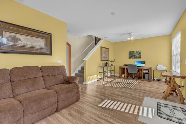 living room featuring ceiling fan and light hardwood / wood-style flooring