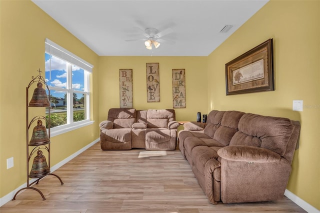 living room featuring ceiling fan and light wood-type flooring