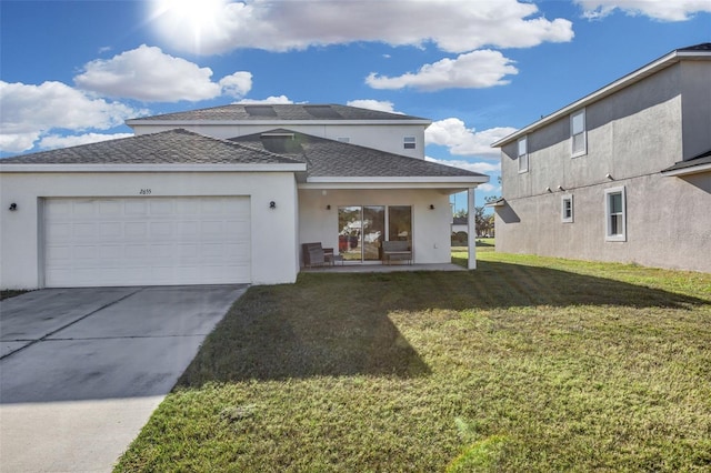 back of house featuring a garage and a lawn