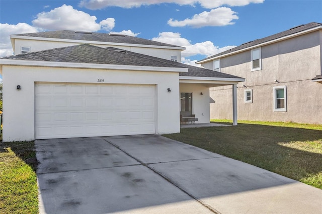 view of front of house with a front yard and a garage