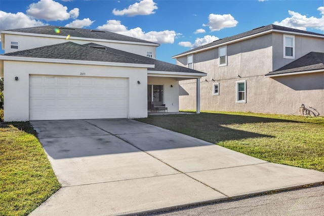 front of property with a garage and a front lawn