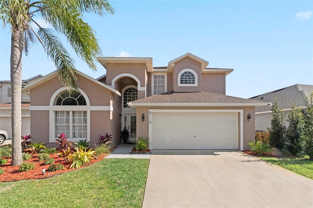 view of front of house featuring a front lawn and a garage