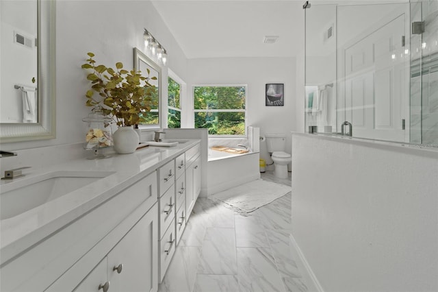 bathroom featuring a shower with shower door, toilet, and vanity