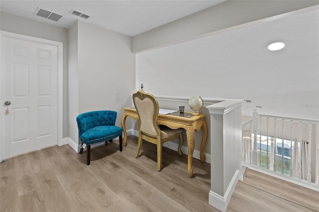 living area with light hardwood / wood-style flooring