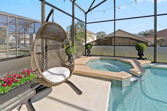 view of pool with glass enclosure and an in ground hot tub