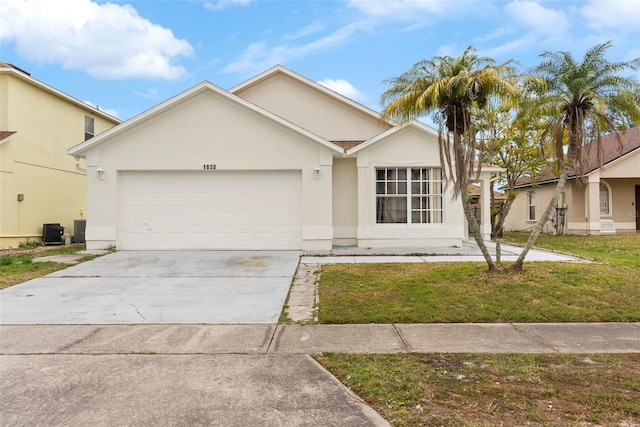 ranch-style home featuring a front lawn, central AC, and a garage