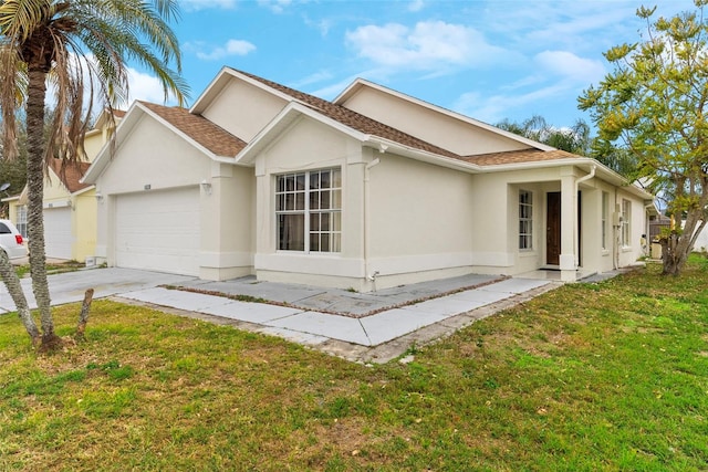 view of front of property with a front yard and a garage