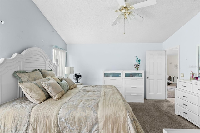 bedroom with vaulted ceiling, ceiling fan, a textured ceiling, and dark carpet