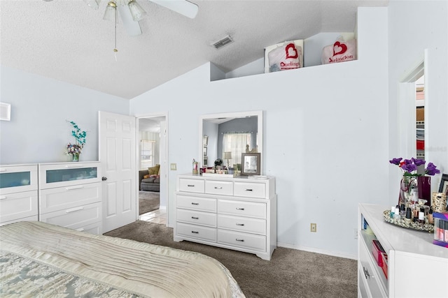 bedroom with ceiling fan, dark carpet, a textured ceiling, and vaulted ceiling