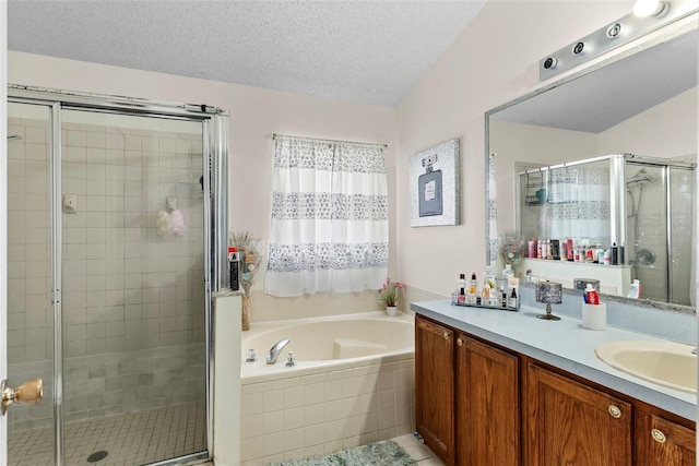 bathroom with vanity, tile patterned flooring, independent shower and bath, and a textured ceiling