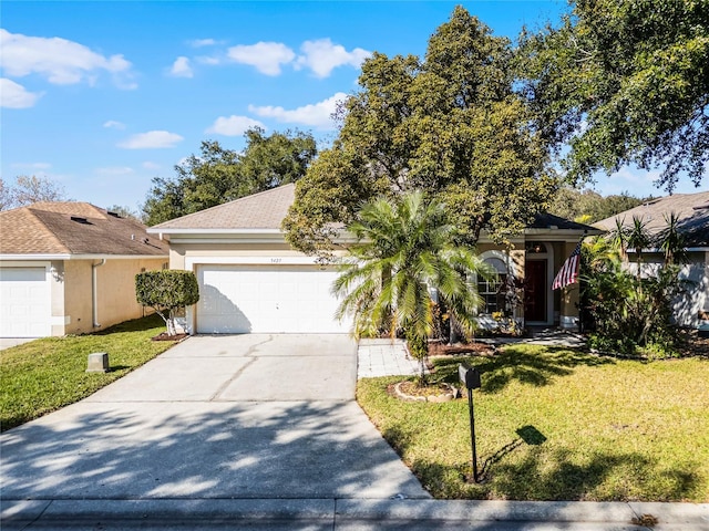 view of front of property featuring a garage and a front lawn