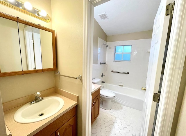 full bathroom featuring tile patterned flooring, vanity, toilet, and tiled shower / bath