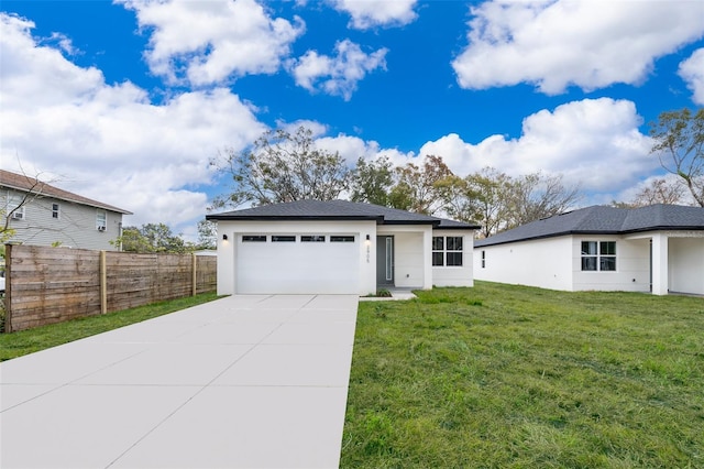 view of front of house with a garage and a front lawn