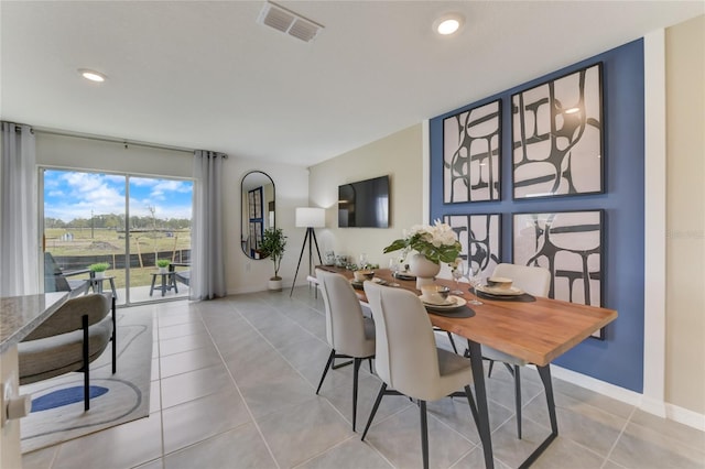 dining space featuring light tile patterned floors