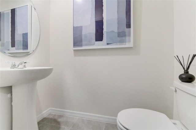 bathroom with tile patterned floors, toilet, and sink