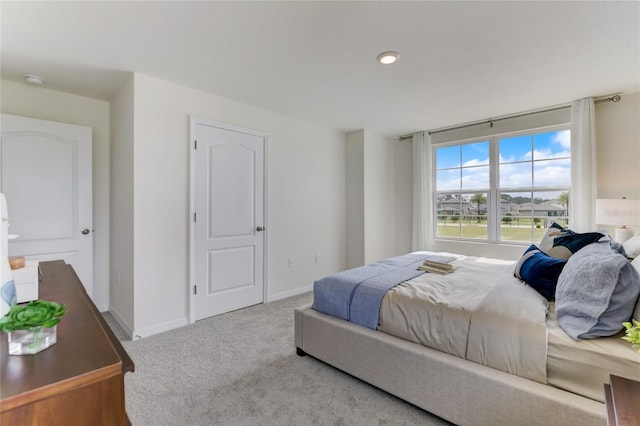 bedroom featuring light carpet