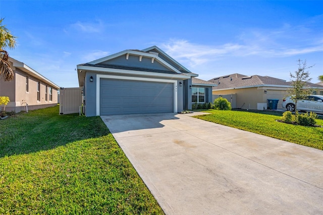 ranch-style house featuring a garage and a front lawn