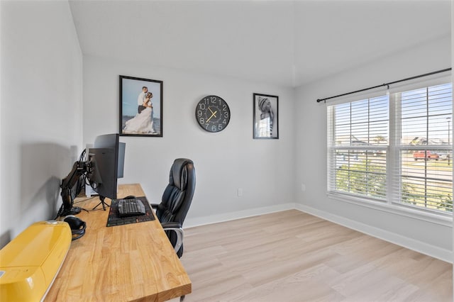 home office featuring a healthy amount of sunlight and light hardwood / wood-style floors