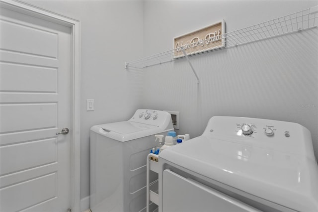 washroom with washing machine and clothes dryer