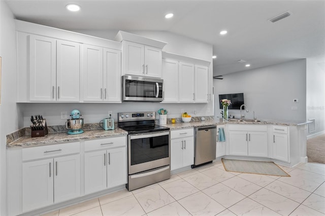 kitchen with sink, white cabinetry, kitchen peninsula, and appliances with stainless steel finishes