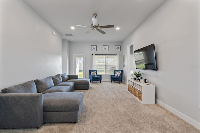 carpeted living room with ceiling fan