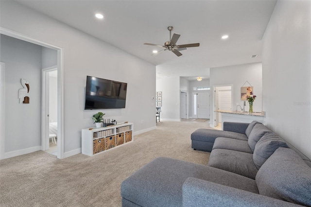 living room with ceiling fan and light colored carpet