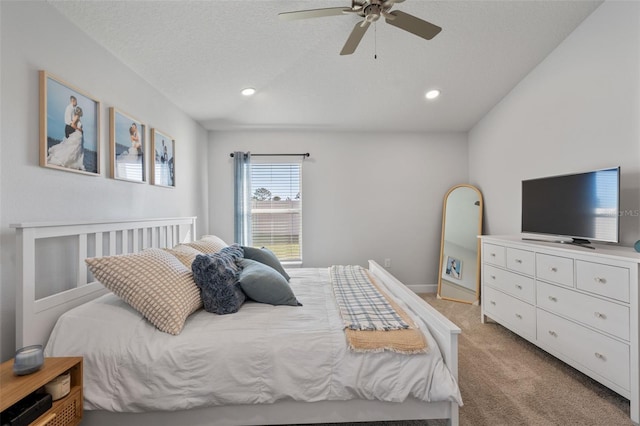 carpeted bedroom with ceiling fan and a textured ceiling