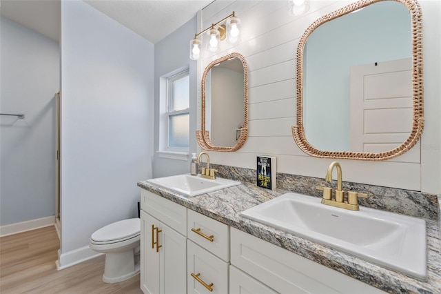 bathroom featuring hardwood / wood-style floors, vanity, and toilet