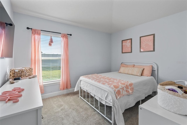 bedroom featuring light colored carpet