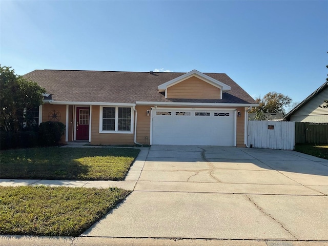 view of front of home with a front yard and a garage