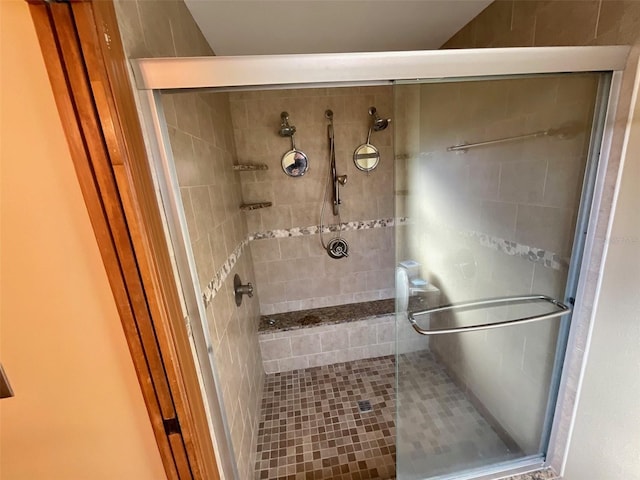 bathroom with a shower with door