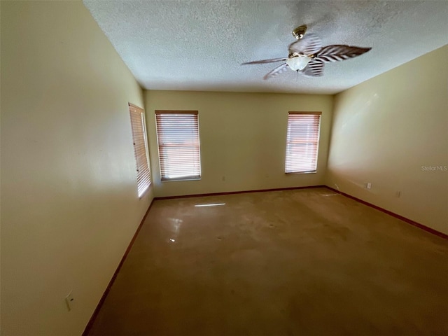 spare room with carpet floors, plenty of natural light, and a textured ceiling