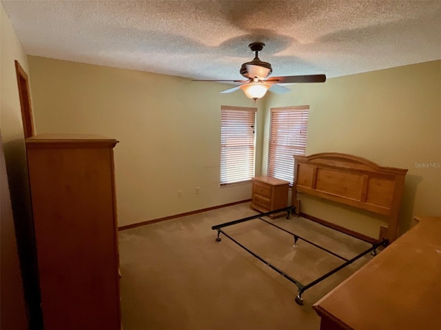 unfurnished bedroom featuring ceiling fan, a textured ceiling, and carpet floors