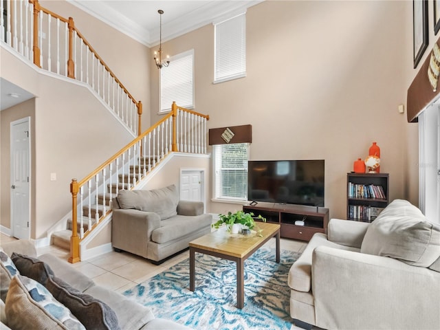 living room featuring a towering ceiling, light tile patterned floors, ornamental molding, and a notable chandelier