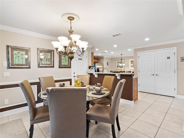 dining room with crown molding, a chandelier, and light tile patterned flooring