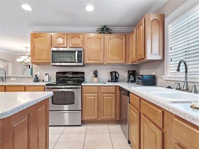 kitchen with light tile patterned floors, appliances with stainless steel finishes, ornamental molding, a chandelier, and sink