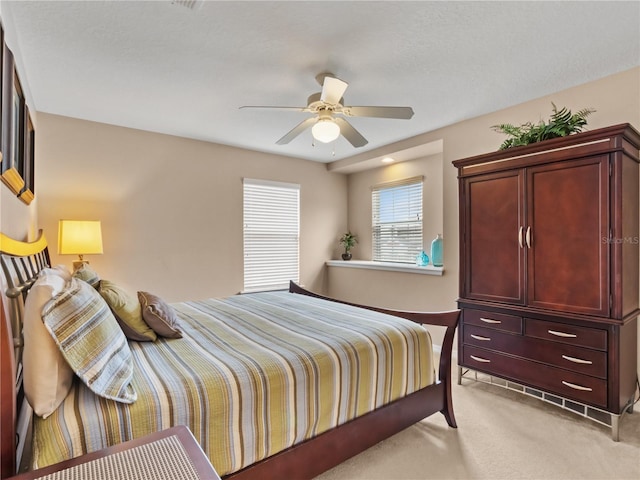 bedroom featuring ceiling fan and light colored carpet