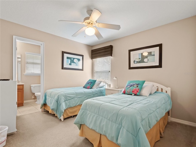 tiled bedroom with ceiling fan and ensuite bathroom