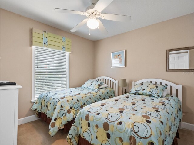 bedroom featuring ceiling fan and carpet