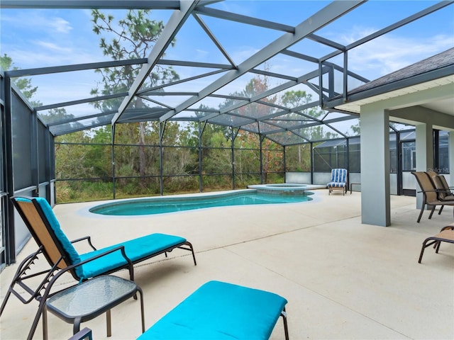 view of swimming pool with a patio area, glass enclosure, and an in ground hot tub