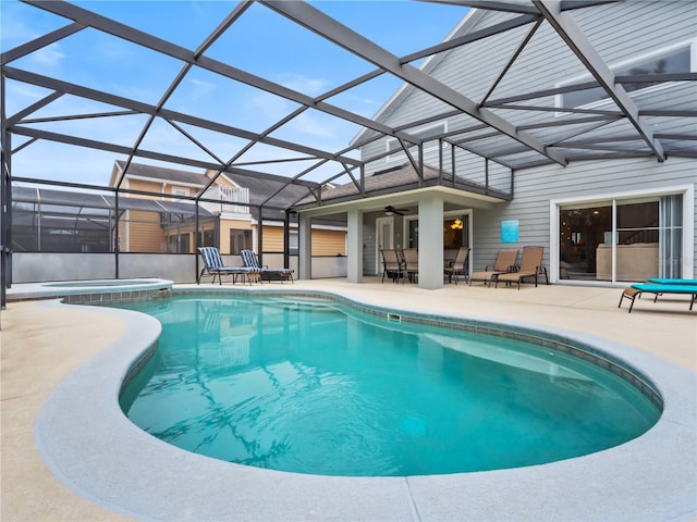 view of pool featuring a lanai, a patio area, and an in ground hot tub