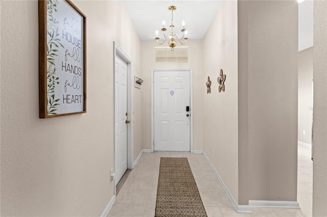 doorway with light tile patterned floors and a chandelier