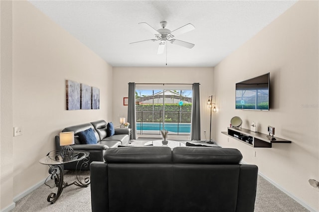 carpeted living room with a textured ceiling and ceiling fan