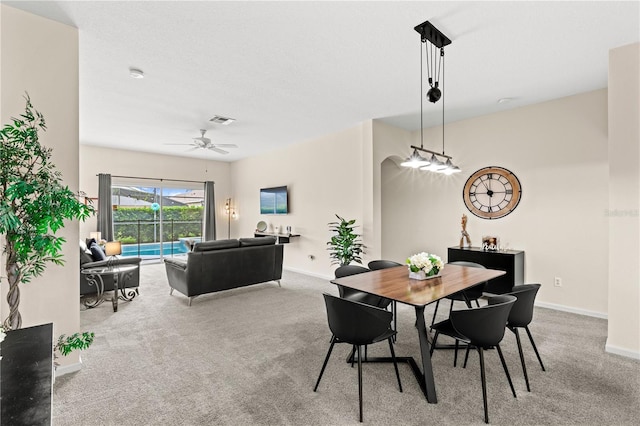 dining area with ceiling fan, a textured ceiling, and carpet flooring