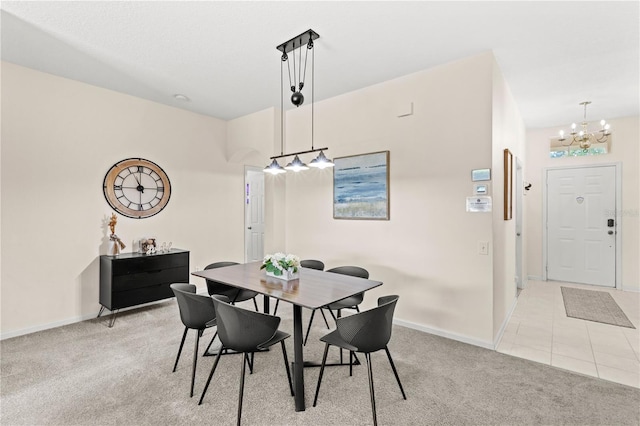 carpeted dining area featuring an inviting chandelier