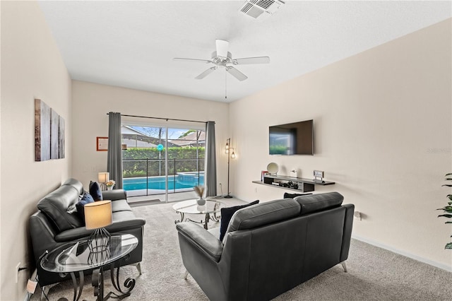 living room with ceiling fan and light colored carpet