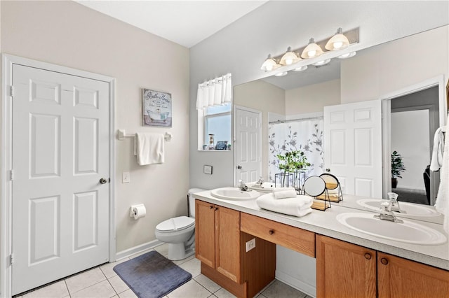 bathroom with toilet, tile patterned flooring, vanity, and curtained shower